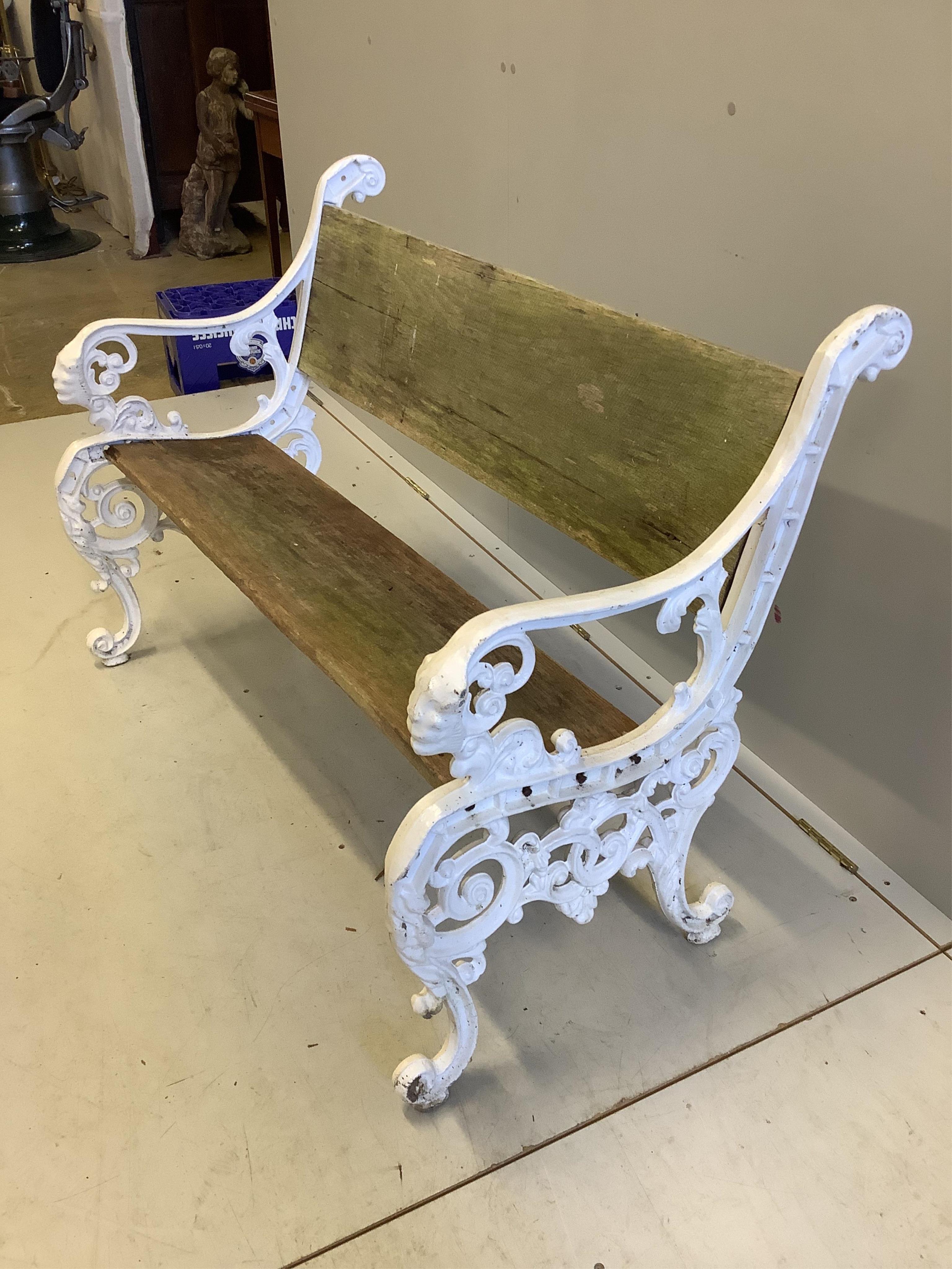 A Victorian cast iron and planked wood garden bench, width 113cm. Condition - fair